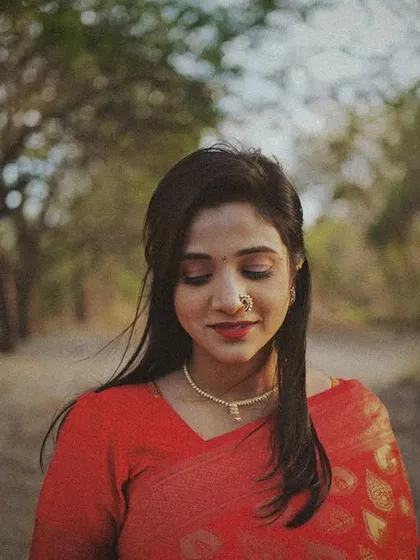 A serene, vintage-toned portrait of a woman with her eyes closed, her hair gently blowing in the wind.