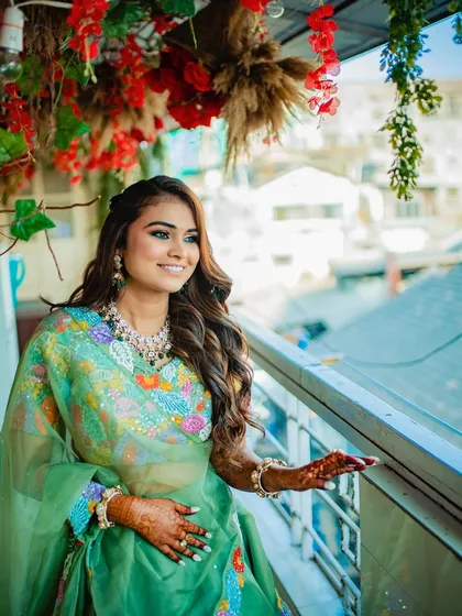 A smiling bride enjoying her event, with her hair styled in simple, elegant waves that last throughout the day.