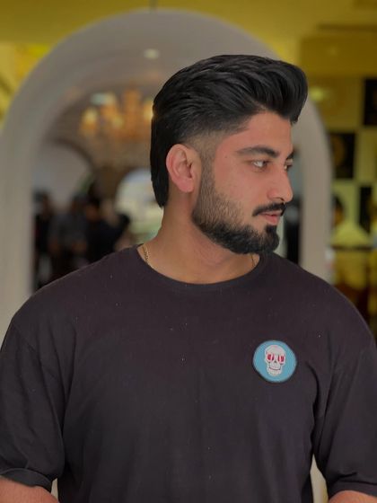 A sharp and stylish haircut for one of our clients. The fade is clean, and the top is styled for volume and texture.