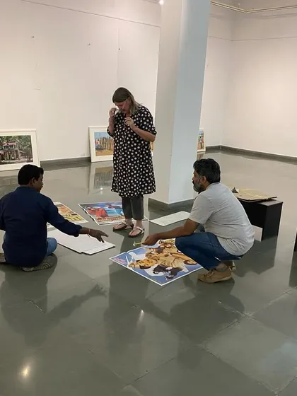 The team on the floor, arranging posters and prints before hanging.