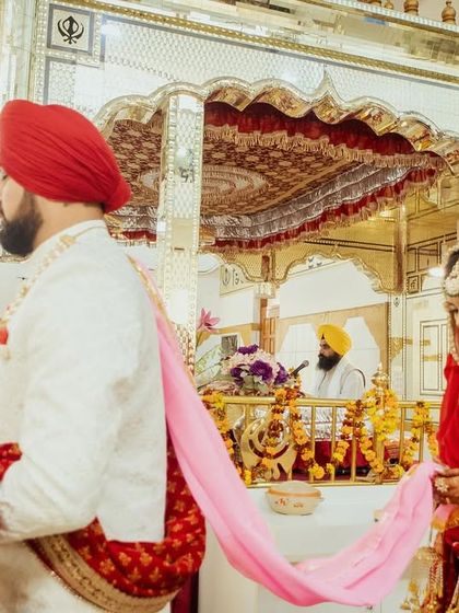 The couple performs a ritual during their Anand Karaj ceremony inside the Gurudwara.