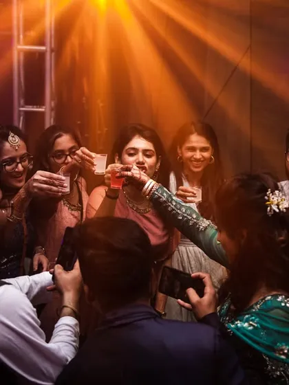 Friends and family raising a toast to the happy couple. A moment of shared celebration.