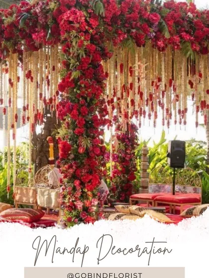 This is a traditional wedding mandap, rich with red flowers covering the pillars and top. I used hanging strings of tuberose, known as rajnigandha, with red flowers at the end to create a classic and auspicious setting for the wedding ceremony.