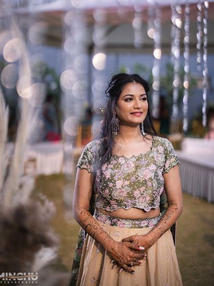 A beautiful candid of the bride at her reception. The soft lighting highlights her glowing skin and the subtle shimmer on her eyes.