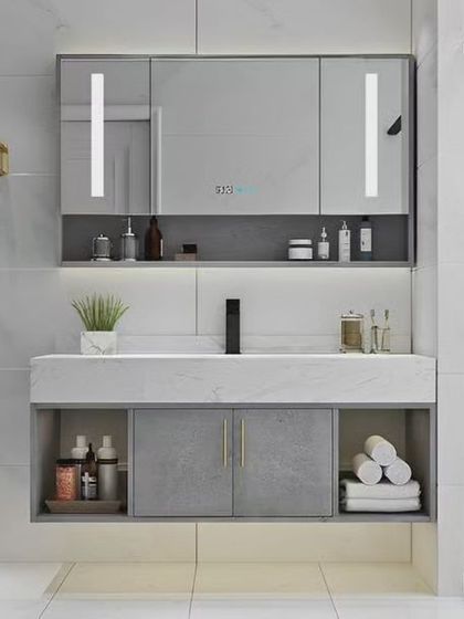 A highly functional bathroom vanity with integrated lighting in the mirror and ample storage. The combination of open and closed cabinets keeps the space organized and clutter-free.