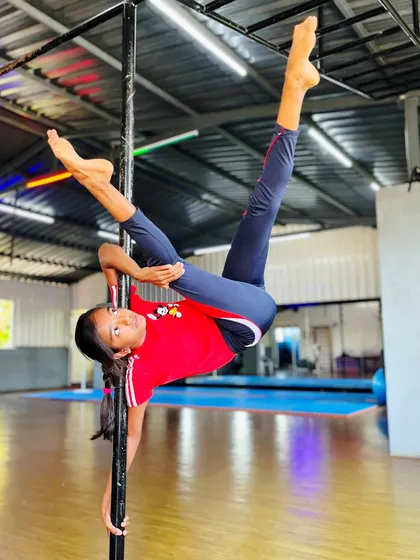 Defying gravity with grace and power. This incredible split on the pole is a testament to the strength, flexibility, and dedication our students develop. We guide each child to safely achieve amazing feats of pole fitness.