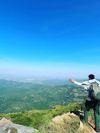 Arms wide open to embrace the sunshine and the stunning 360-degree view from the top of Skandagiri.