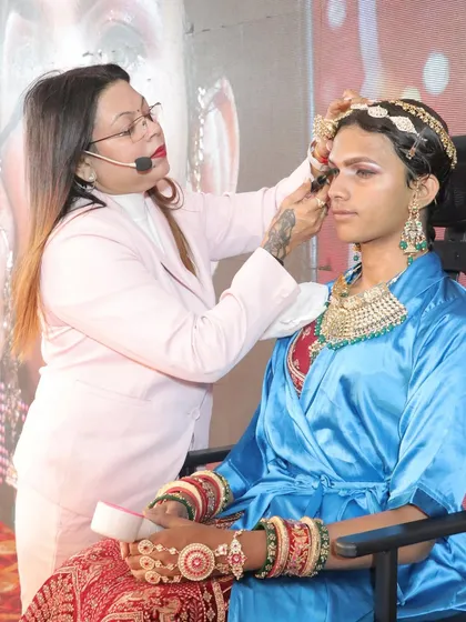 Here I am, live on stage during a seminar, demonstrating a complete boy-to-girl bridal transformation. My teaching is always practical and hands-on, ensuring you see exactly how to execute complex looks.