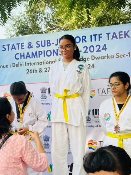 A student receives her medal at the 3rd Delhi State Championship.