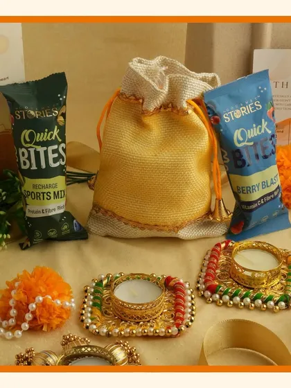 Brighten up your celebrations with our vibrant orange Navratri and Diwali hampers, filled with small treats and decorative diyas.