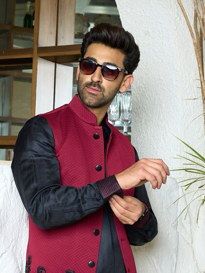 The epitome of refined luxury. This black kurta and maroon waistcoat combination is perfect for making a statement at any gathering, from formal galas to sophisticated soirees.