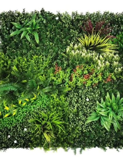 A sample panel of a mixed tropical green wall. It includes artificial ferns, broadleaf plants, and colorful accents, showing the variety available for custom designs.