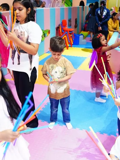 Children engaged in a fun, interactive activity with wands during a magical fairy garden birthday party.