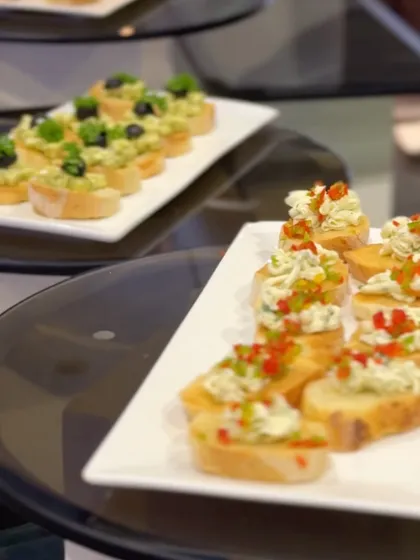 A platter of assorted bruschetta, featuring toppings like olive tapenade and fresh tomato salsa. A classic Italian appetizer, beautifully presented.