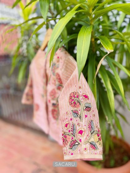 A detailed shot of the sleeve of our pink Kalamkari patchwork blouse, showing the intricate floral embroidery.