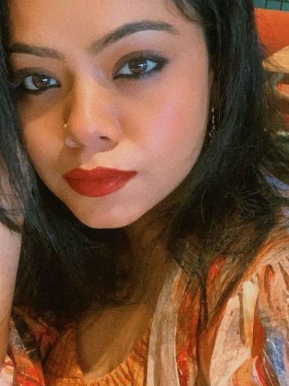 A classic makeup look with winged eyeliner and a rich red lipstick. This is a timeless choice that adds instant glamour to any outfit.