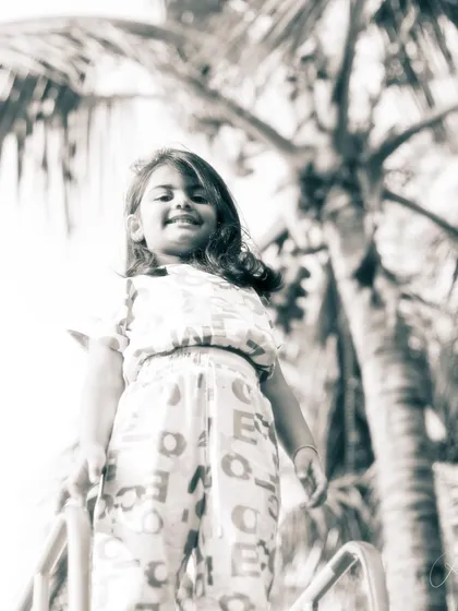 A low-angle, black and white shot that makes her look like she's on top of the world. This captures the confidence and carefree spirit of childhood.