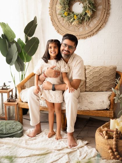 A proud dad with his daughter. This simple and happy portrait captures their close bond in our relaxed, boho-themed studio.