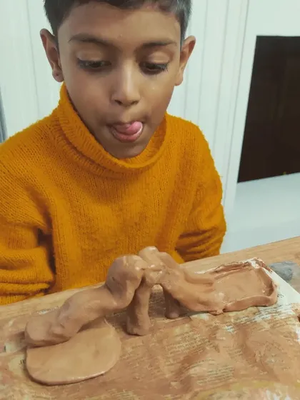 The pure, unfiltered concentration of a young artist at work. My kids' clay sessions are all about letting them explore, get messy, and bring their wildest ideas, like this amazing bridge, to life.