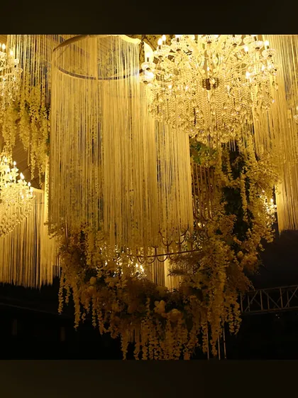 A ceiling installation of hanging tuberoses and crystal chandeliers, creating a fragrant and visually stunning canopy.