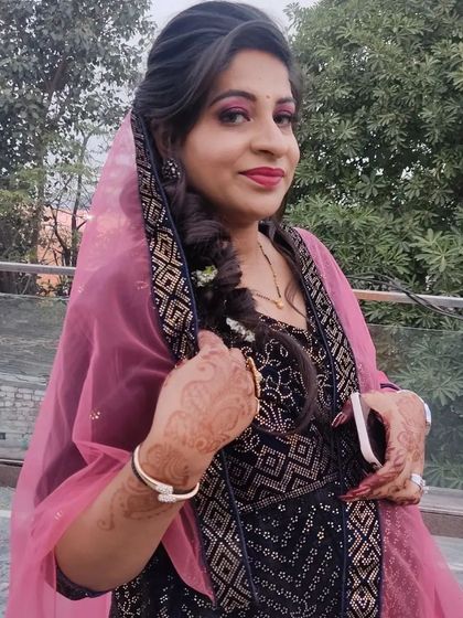 A client looking beautiful with a braided hairstyle and party makeup, paired with one of my rental outfits.