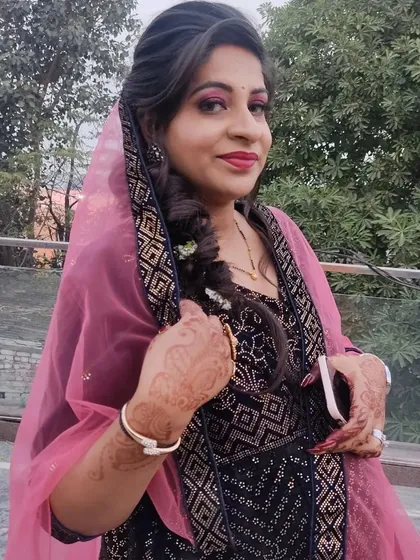 A client looking beautiful with a braided hairstyle and party makeup, paired with one of my rental outfits.