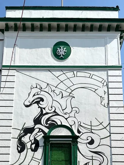 The completed minimal horse mural, standing tall on the iconic racecourse building. A clean, powerful design that respects the heritage of the location.
