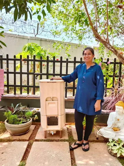 A happy customer standing proudly next to her Terrabite composter in her garden. This unit is perfect for those who want a continuous composting system without any heavy lifting or shifting of parts.