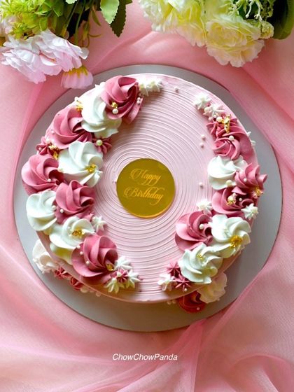 Another overhead shot of the pink and white floral cake, showing the arrangement of the buttercream swirls.