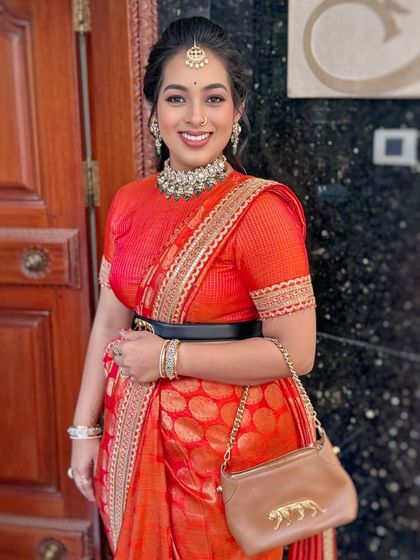 The bride's radiant smile is the highlight of this look, complemented by glowing makeup and a simple, elegant hairstyle.