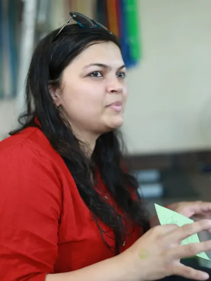A close-up candid portrait of a woman actively participating in the discussion.