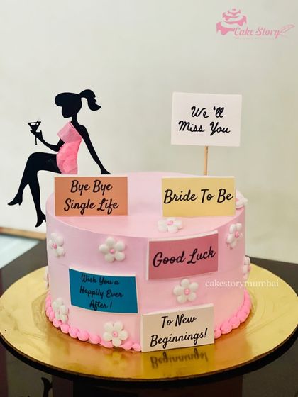 A sweet and simple 'Bride to Be' cake to say 'Bye Bye Single Life'. This pink cake is decorated with messages of good luck and new beginnings for the bride.