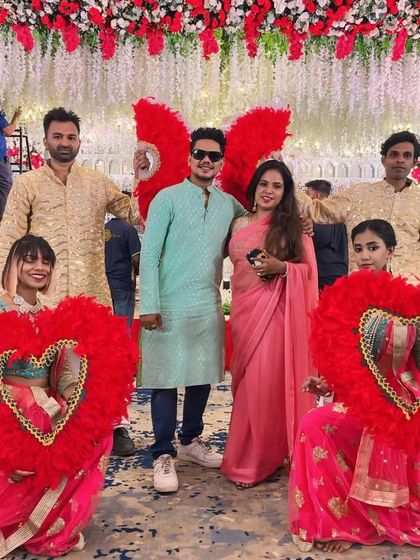 We provide creative props to make your entry unique. For this couple's entry, our dancers used large, feathered heart props to create a beautiful and romantic pathway.