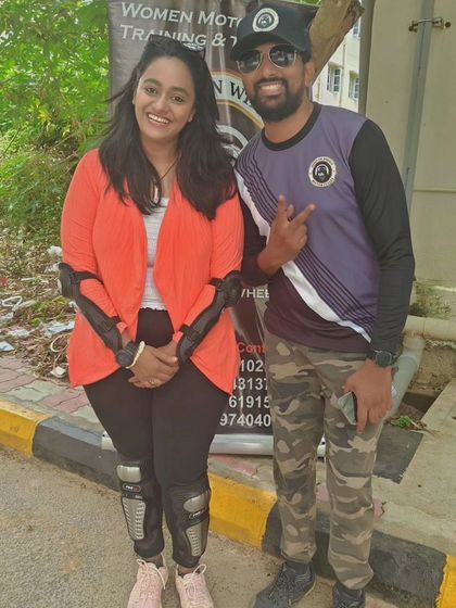 A graduate celebrates with her coach. This photo captures the supportive relationship we build with every student.