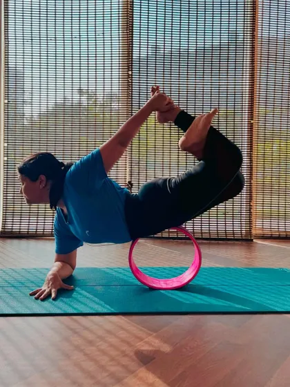 This is a beautiful and challenging yoga pose inspired by another yogi. My student is demonstrating incredible flexibility and balance. It's wonderful to see her progress.