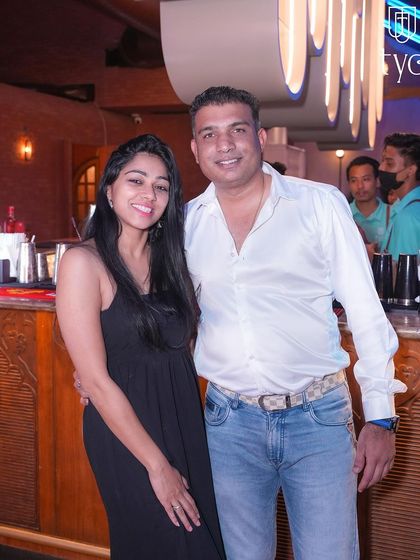 A couple posing by the bar at TYD.