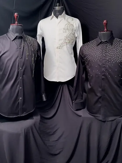 Three of my exclusive shirts on display. The collection includes a black shirt with cascading beads, a white shirt with a gold-embroidered tiger, and a black shirt with pearl embellishments.
