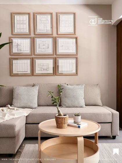 A magazine feature showcasing the cozy corner of the study with a comfortable L-shaped sofa and the gallery wall of cherished family sketches.