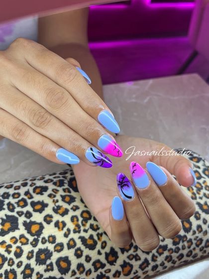Bringing sunset beach vibes to your fingertips. This design features a pink and purple ombré with black palm tree silhouettes against a light blue base.