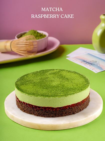 My Matcha Raspberry Cake, a perfect balance of earthy and tart. A vibrant green matcha mousse sits atop a layer of raspberry compote and a rich chocolate base.