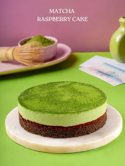 Our Matcha Raspberry Cake, a unique creation combining earthy green tea flavor with the tartness of raspberries, all on a rich chocolate base.