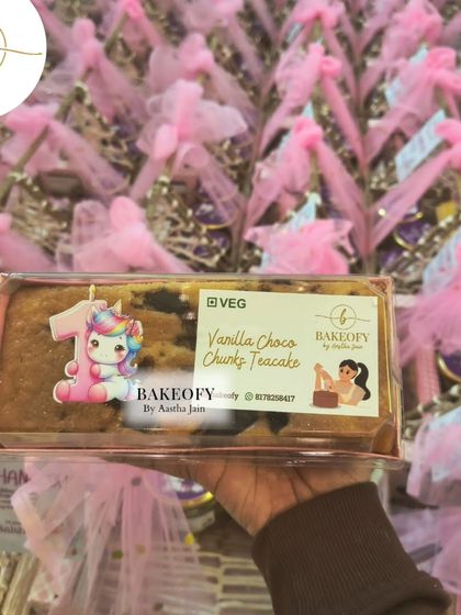 Our Vanilla Choco-Chunky Teacake, specially packaged for the birthday return favors. The custom unicorn sticker adds a touch of magic to this delicious, eggless cake.