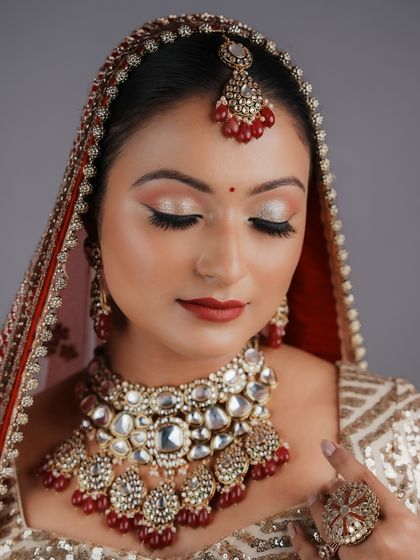 A classic bridal look with red lips and winged liner, perfectly executed by a student. They have mastered the fundamentals and are ready for clients.