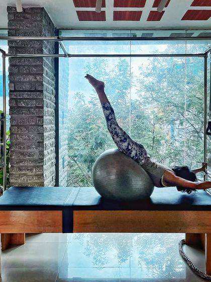 Physical elegance is a dance of symmetry and poise. This client uses the stability ball on the Cadillac to create beautiful lines and challenge her core.