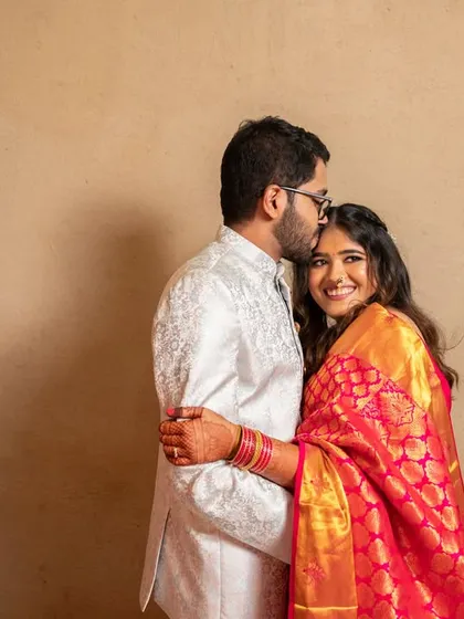A tender forehead kiss. This is a classic romantic pose that is always full of love and emotion.