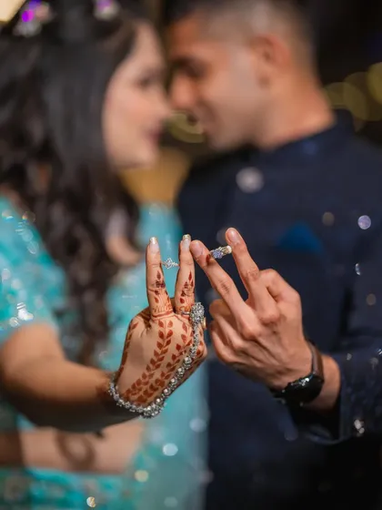 A creative ring shot where Diksha and Vighnesh show off their engagement rings. This playful pose is a great way to announce that you're officially engaged.