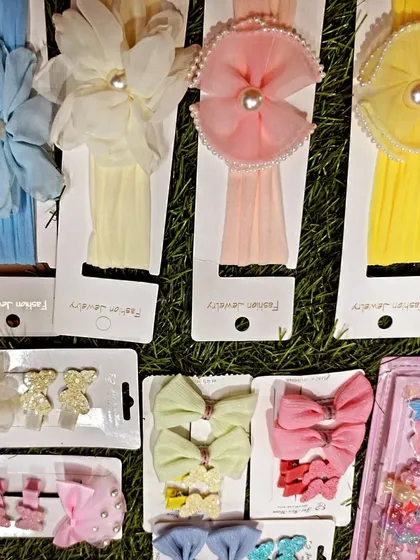 I have a large variety of hair bands and clips, including these soft floral headbands for younger children and cute bow clips in pastel colors.