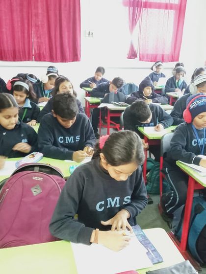 A classroom full of young artists, focused on their creations. We are grateful to our partner schools for their enthusiastic participation in these events.