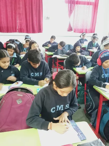 A classroom full of young artists, focused on their creations. We are grateful to our partner schools for their enthusiastic participation in these events.