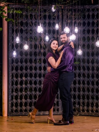 The combination of hanging Edison bulbs and the rustic gate creates an industrial-chic vibe, offering a unique and moody background for your night shoot.